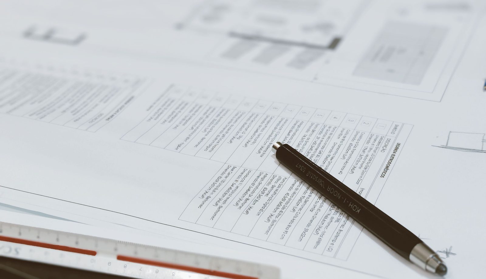 Printed process documents and a pen on a desk